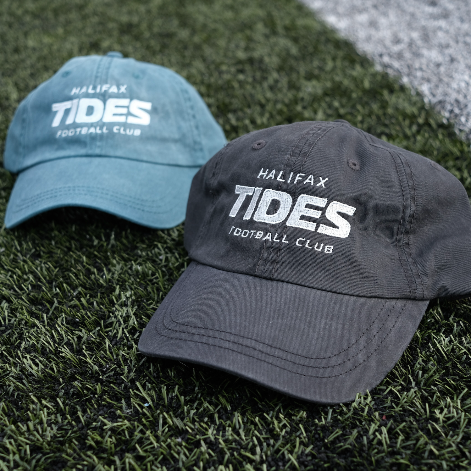 Halifax Tides FC Wordmark Hats on soccer pitch